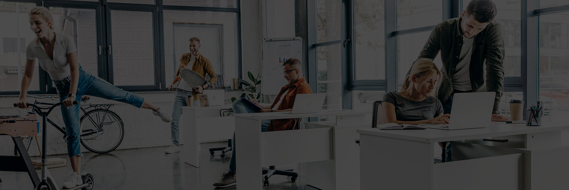 Open office with people working and interacting.